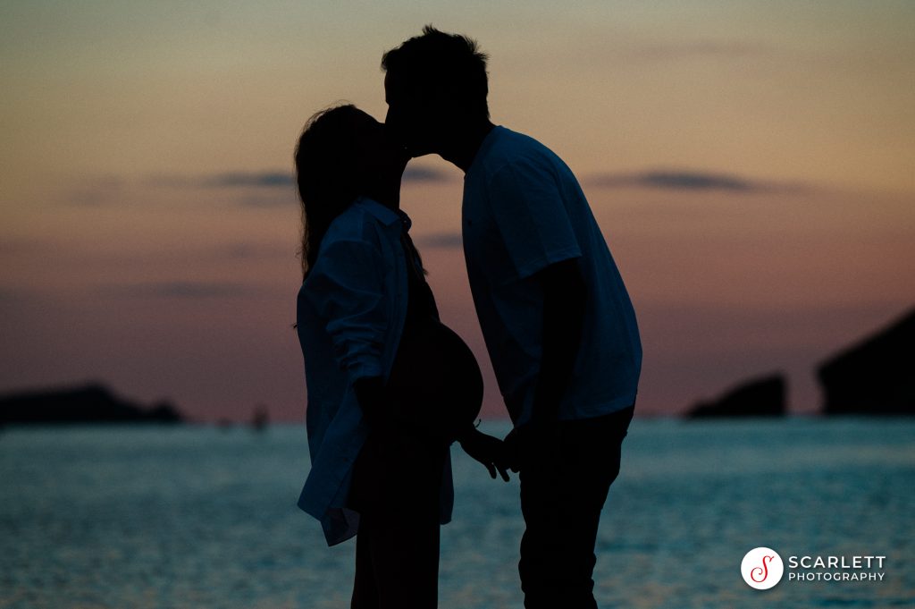 Baby bump couple at sunset at Porth beach