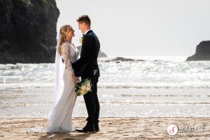 Wedding Couple look into each others eyes on the beach in Cornwall