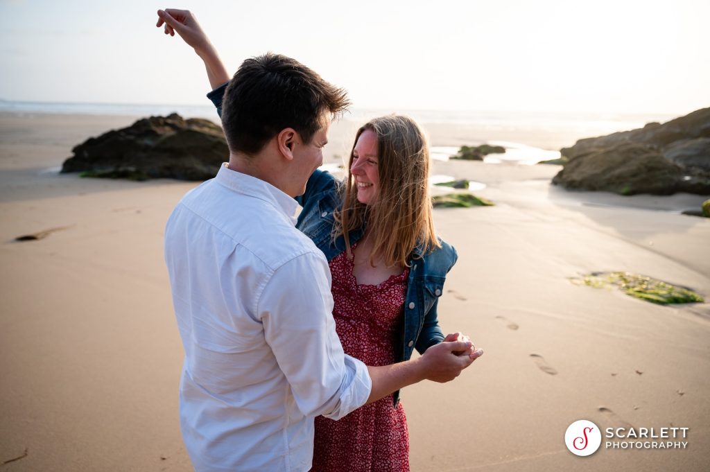 Dancing into a huge embrace after accepting her proposal on Watergate bay beach near Newquay
