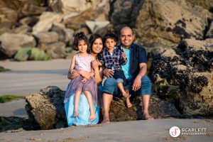 Beautiful family group photograph at Lust glaze sitting on a rock drenched in the golden hours sunshine