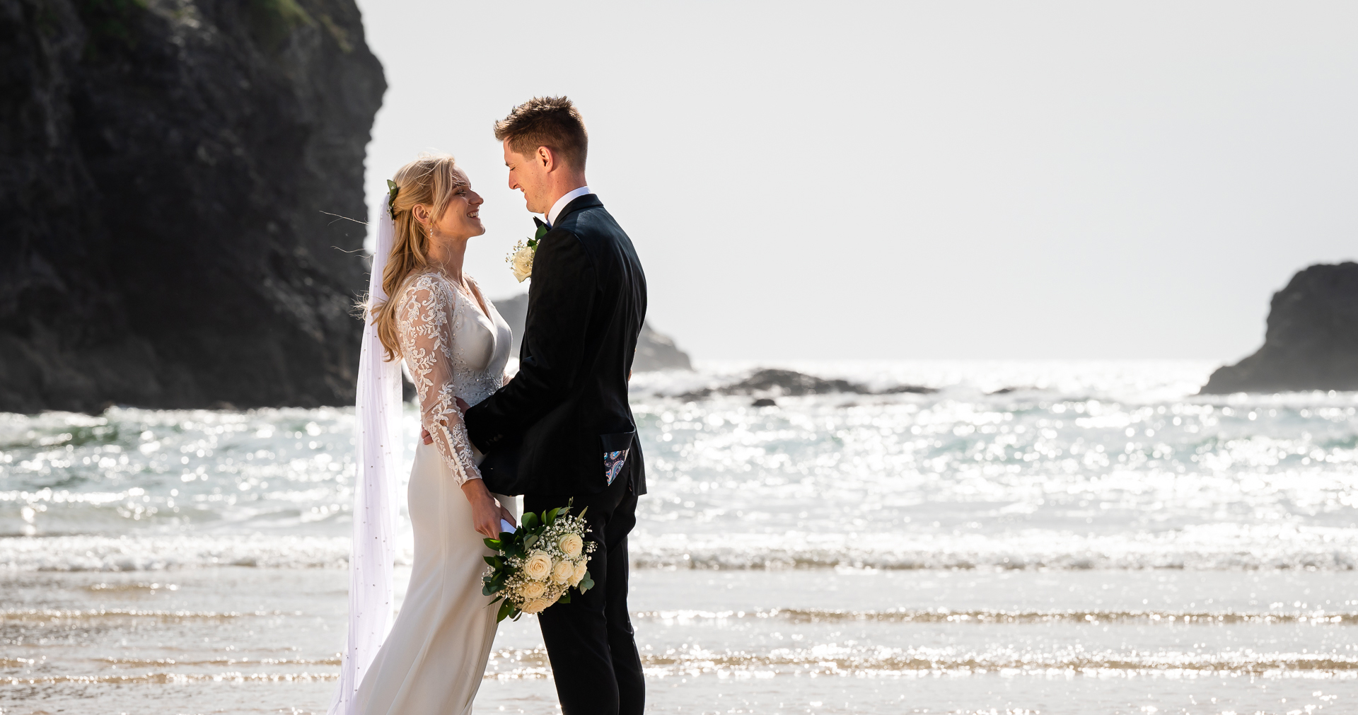 wedding couple on Cornish beach with the cliffs and sea as a backdrop
