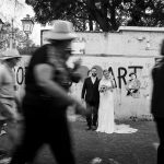 Couple walking through Sorrento streets on their wedding day, captured by Cornwall wedding photographer Scarlett Photography